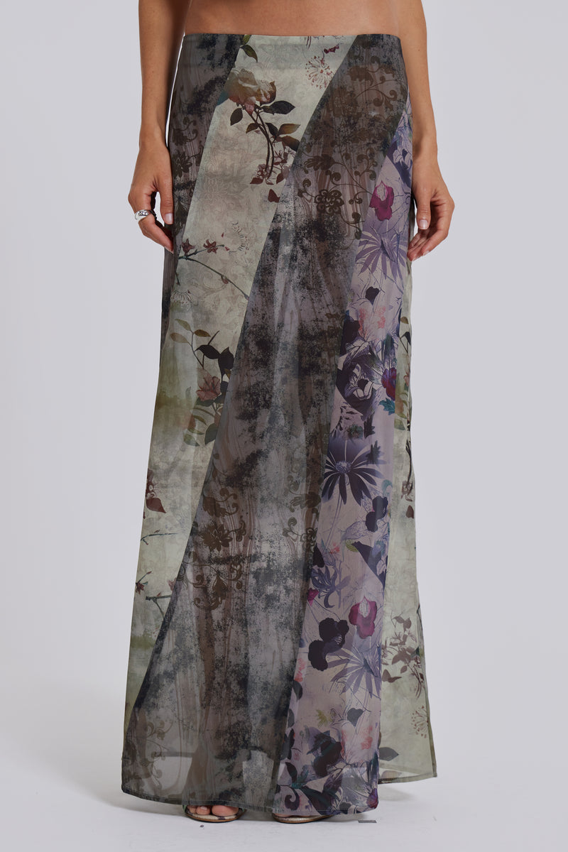 Female model wearing a floral maxi length skirt with panelled patchwork detail. Styled with the matching cowl neck top. 
