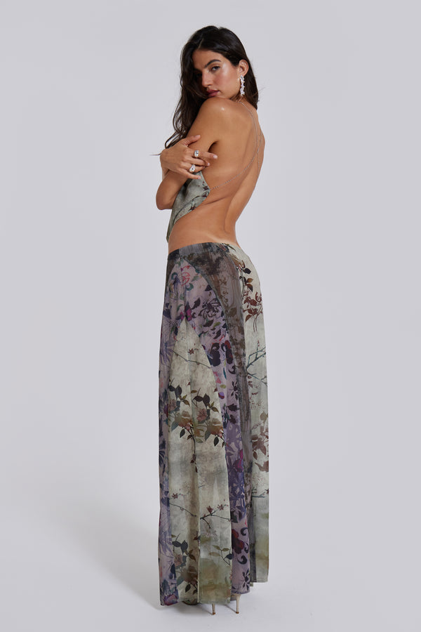Female model wearing a floral maxi length skirt with panelled patchwork detail. Styled with the matching cowl neck top. 