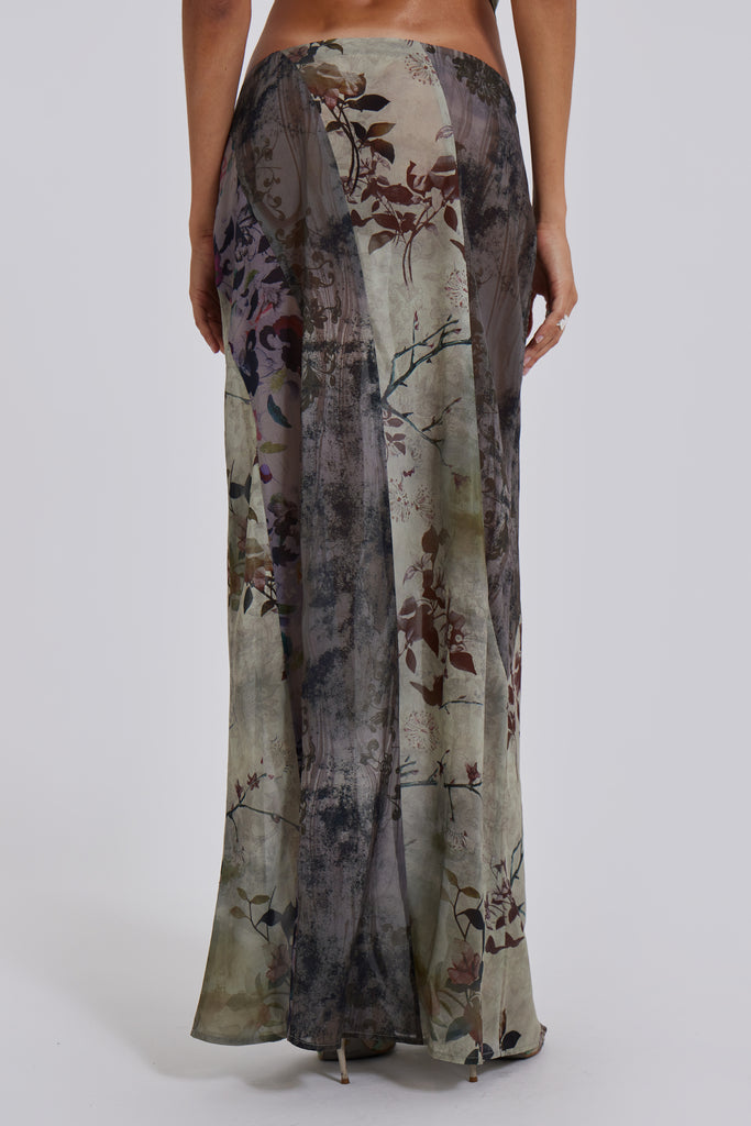 Female model wearing a floral maxi length skirt with panelled patchwork detail. Styled with the matching cowl neck top. 