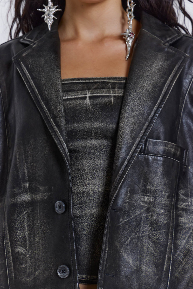 Introducing the Ash Blazer - crafted from a faux leather PU fabric with a unique heavy acid wash finish in an off-black colourway, this oversized fit blazer features a two-button front, jet pockets with flaps on the chest and a back vent, the blazer is fully lined and perfect for layering.